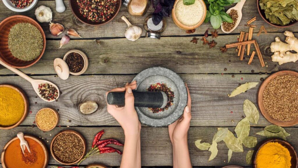 17 Items You Should Always Buy on the Cheap Hands grinding pepper with mortar and pestle