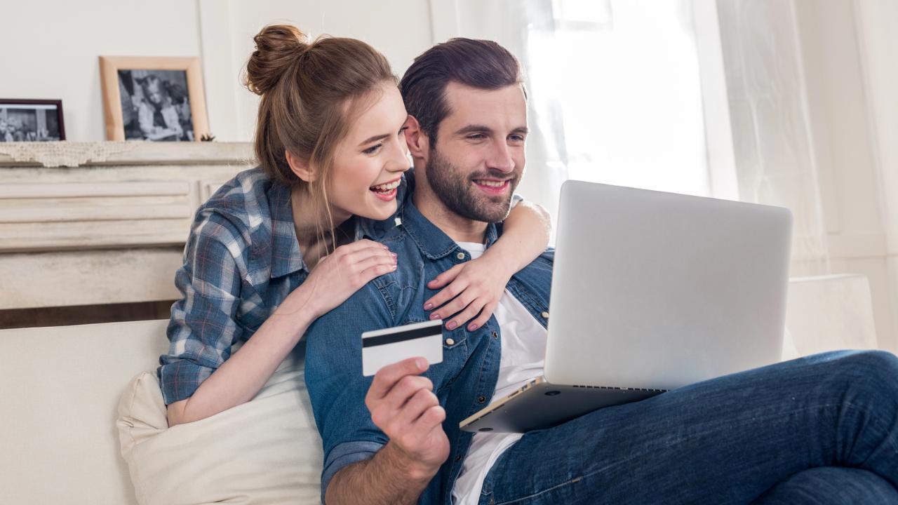 Couple shopping online using a credit card